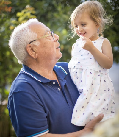 picture with man wearing glasses and holding a child
