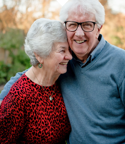 Picture of a couple that includes a lady and a man who is wearing glasses